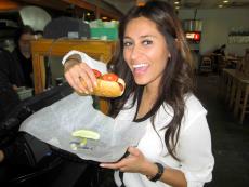 Customer enjoying hot dog at Backyard Grill in Chicago Customer enjoying hot dog at Backyard Grill in Chicago