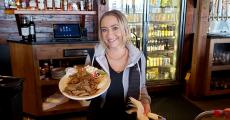 Friendly server with gyros at Niko's Tavern in Elgin Friendly server with gyros at Niko's Tavern in Elgin
