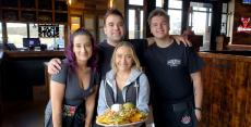 Friendly staff with nachos at Niko's Tavern in Elgin Friendly staff with nachos at Niko's Tavern in Elgin