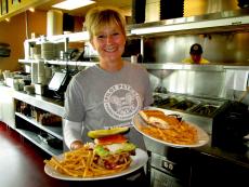 Friendly waitress serving sandwiches at Pilot Pete's Restaurant in Schaumburg Friendly waitress serving sandwiches at Pilot Pete's Restaurant in Schaumburg